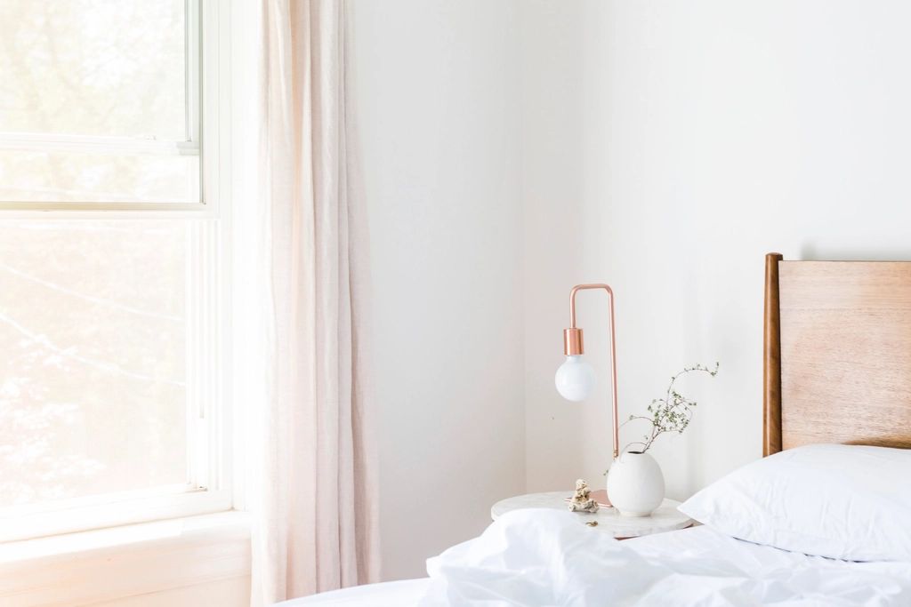 A guest room with a large bed and soft lighting